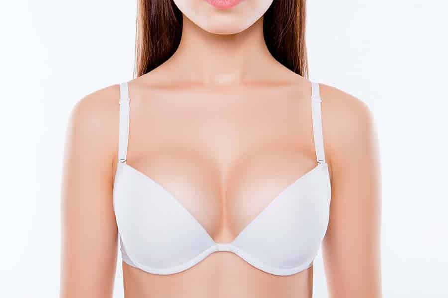 Photo of sexy woman's breast wearing white classic elegant brassiere