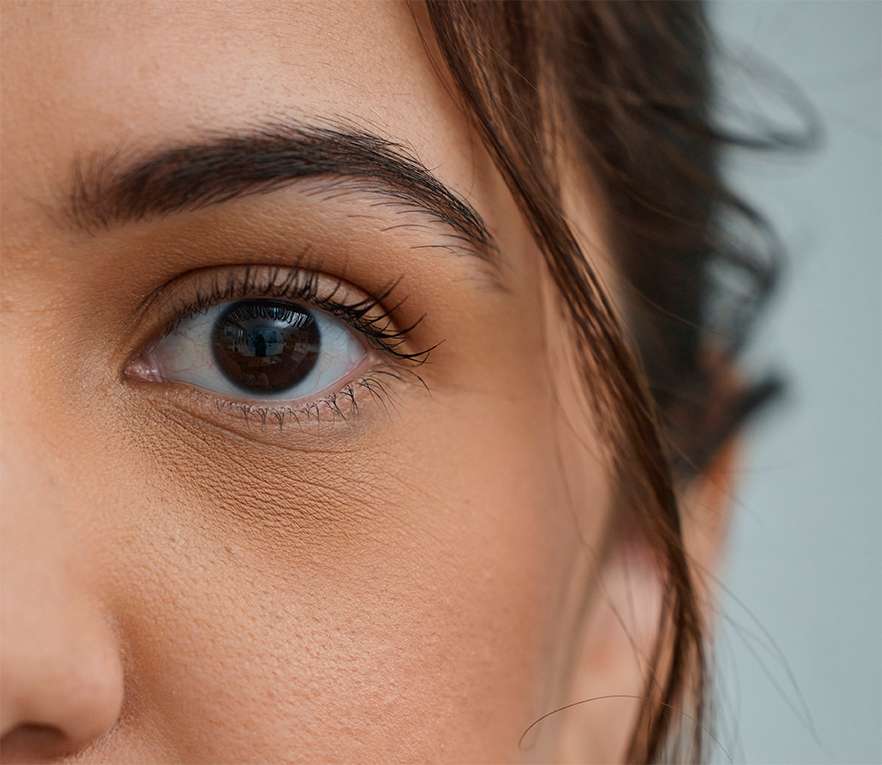Woman, eye and zoom in portrait by space, mockup or health for vision, contact lens or biometric test. Girl, model and closeup for cybersecurity banner, retina or cornea scan for safety by background